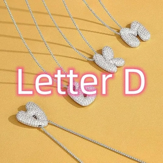 Brass zircon balloon English letter necklace in gold finish, copper base with inlaid zircon stones, on a woman's collarbone