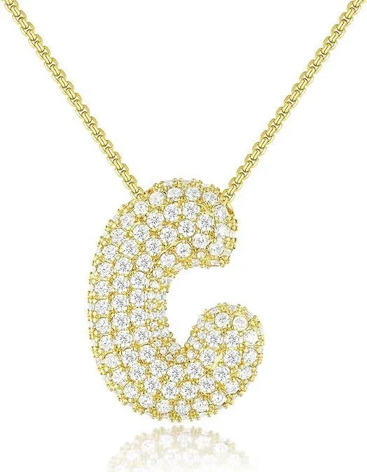 Brass zircon balloon English letter necklace in gold finish, copper base with inlaid zircon stones, on a woman's collarbone