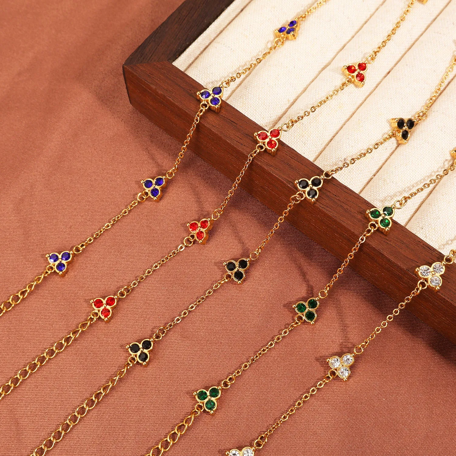 Women's stainless steel geometric bracelet with three diamond triangle design and coloured stone accents