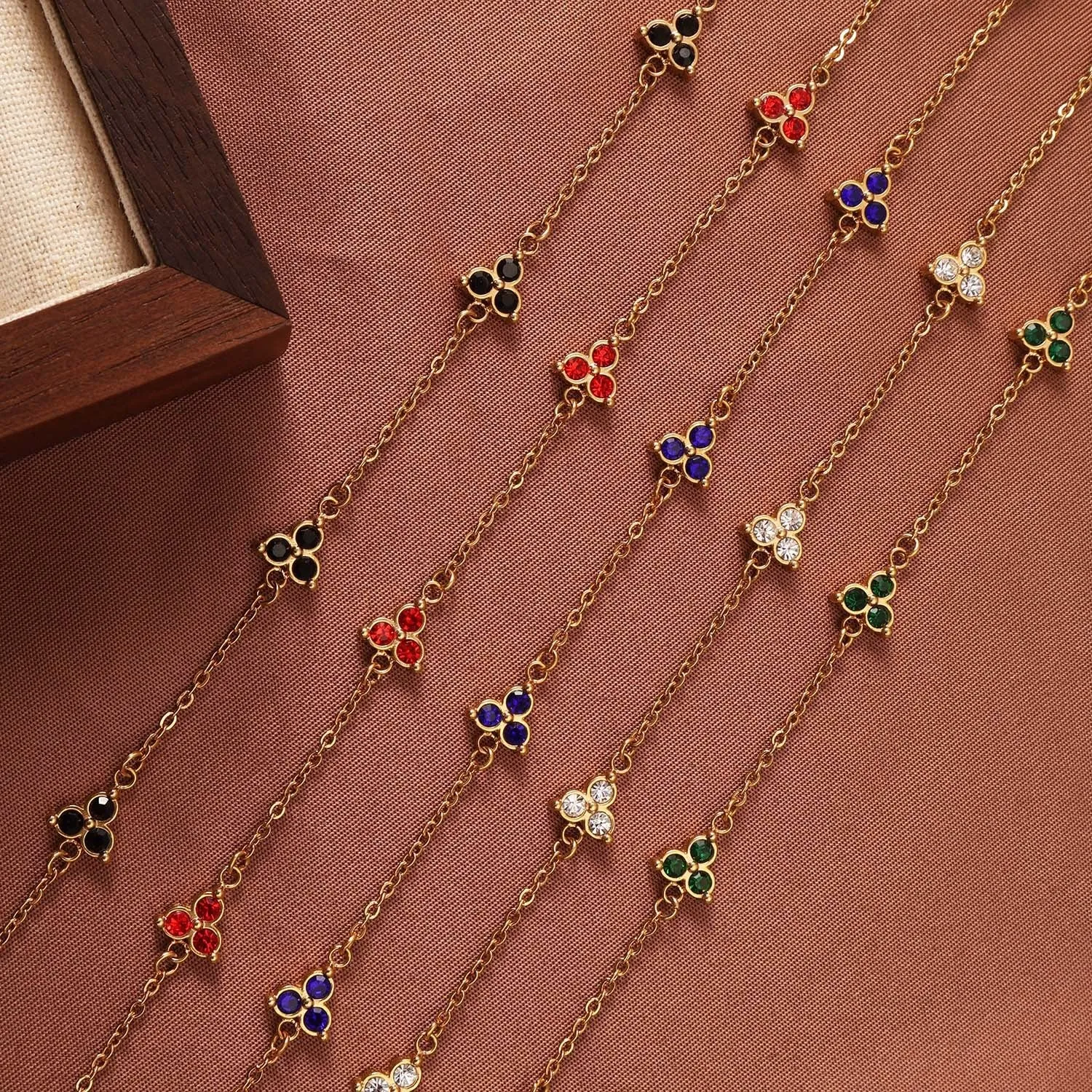 Women's stainless steel geometric bracelet with three diamond triangle design and coloured stone accents