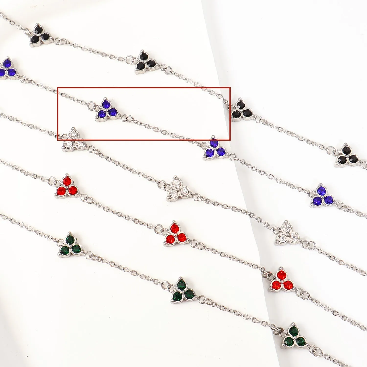 Women's stainless steel geometric bracelet with three diamond triangle design and coloured stone accents