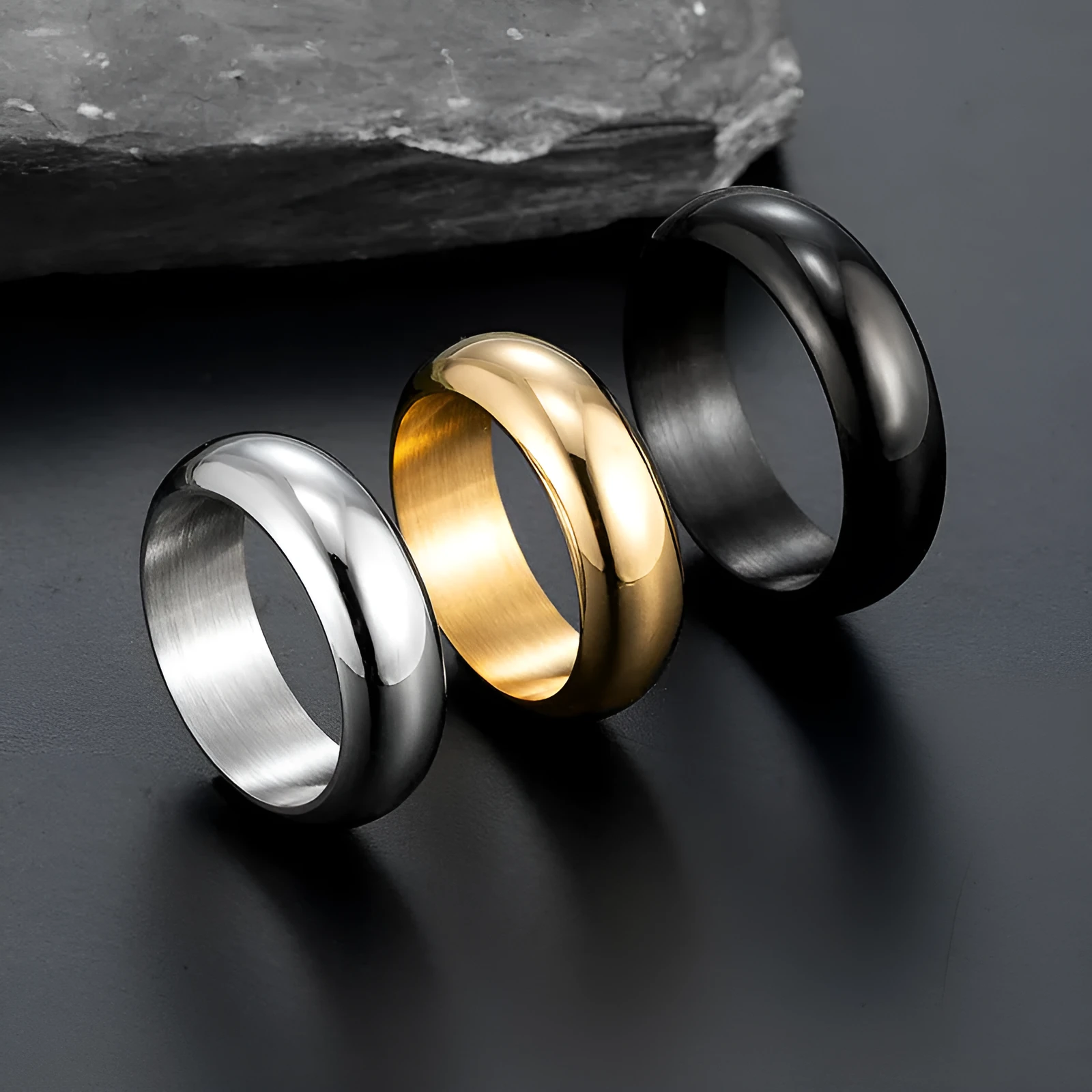 Glossy electroplated titanium steel ring shown in gold, black, and steel colour on a plain background.