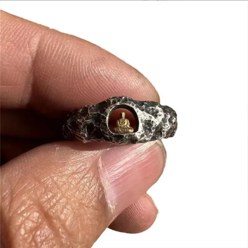 Hand-forged copper Buddha ring with grotto rock texture, shown on a size 8 finger.