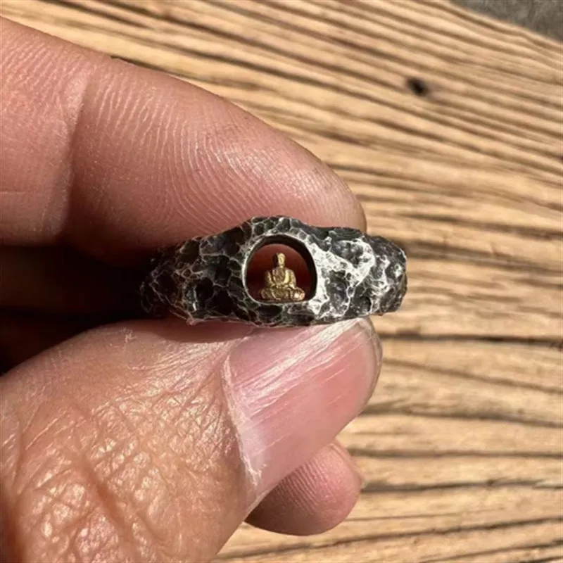 Hand-forged copper Buddha ring with grotto rock texture, shown on a size 8 finger.