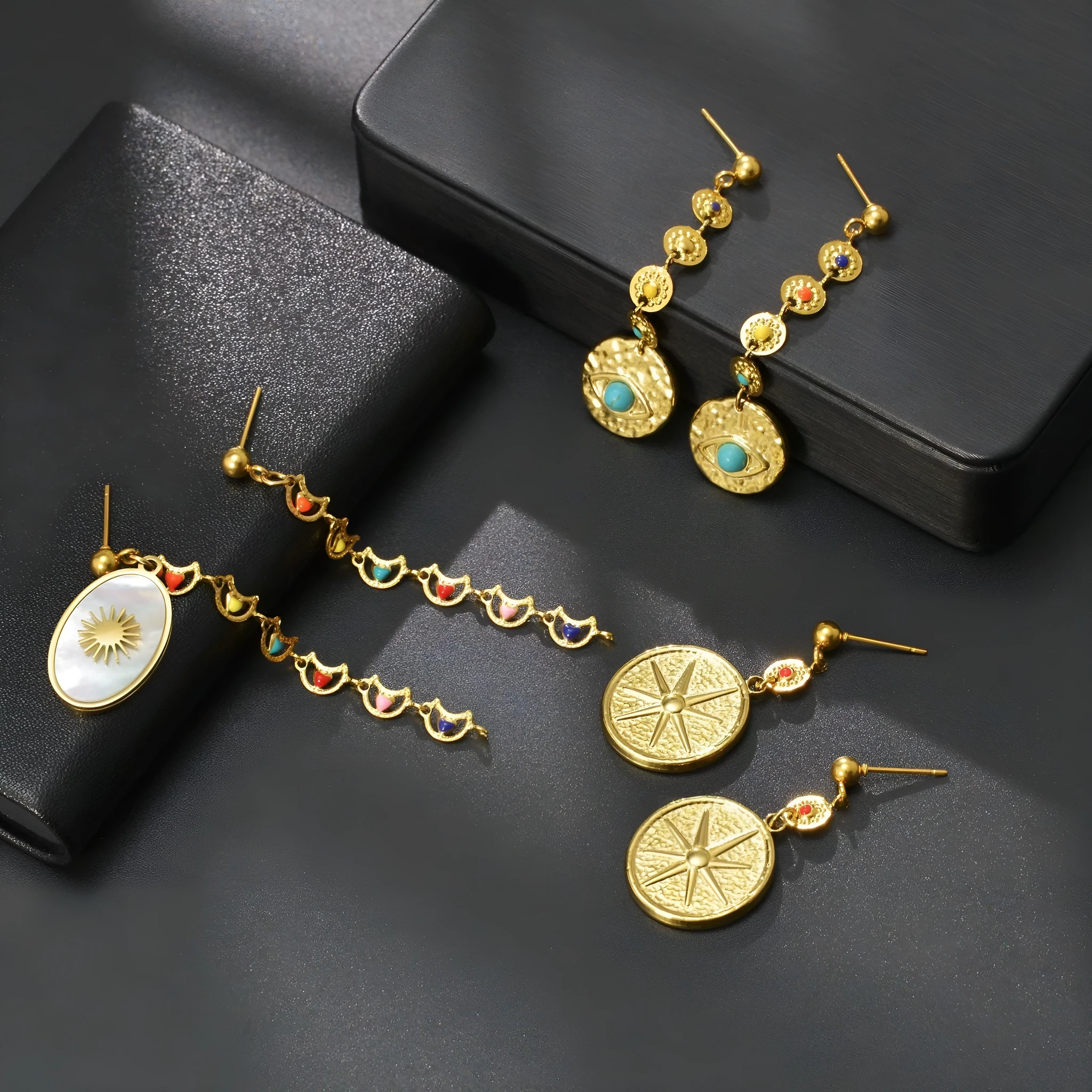 Stainless steel geometric earrings showing star, eye and shell sun design variations