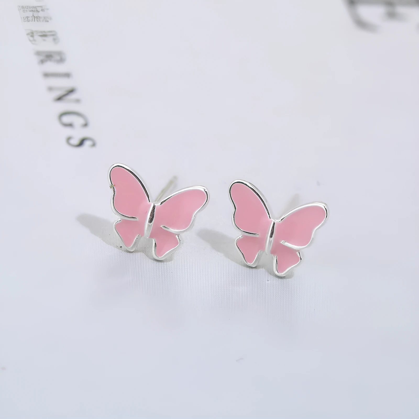Side view of 925 silver butterfly stud earrings with geometric shape and plating finish