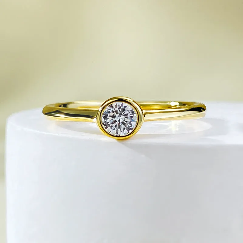 Minimalist crown-shaped silver ring in gold or platinum finish, shown in a simple setting.
