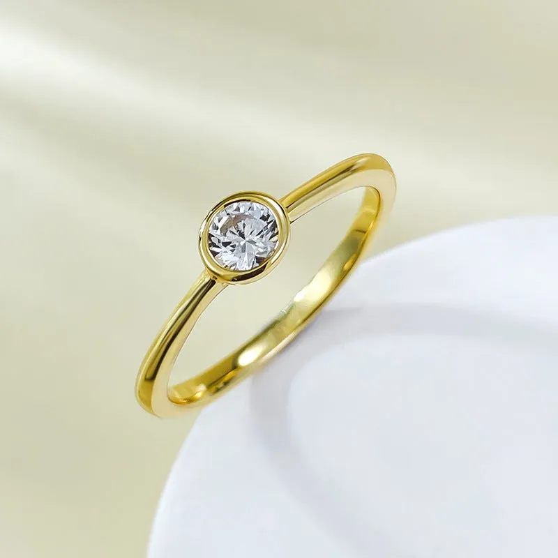 Minimalist crown-shaped silver ring in gold or platinum finish, shown in a simple setting.