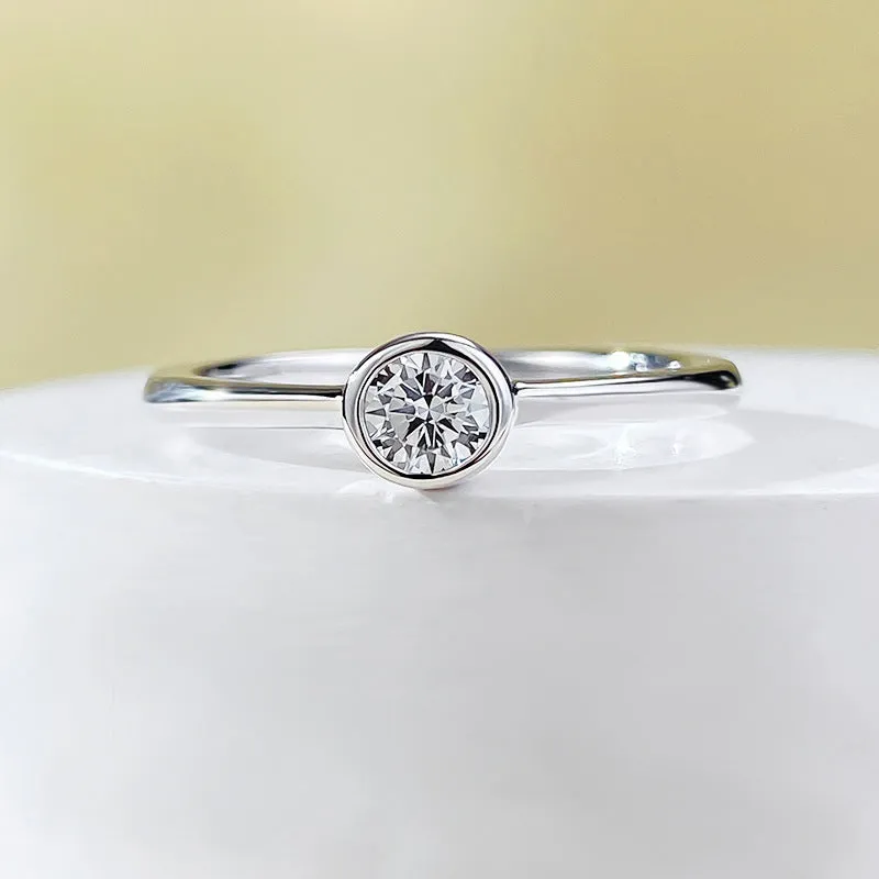 Minimalist crown-shaped silver ring in gold or platinum finish, shown in a simple setting.