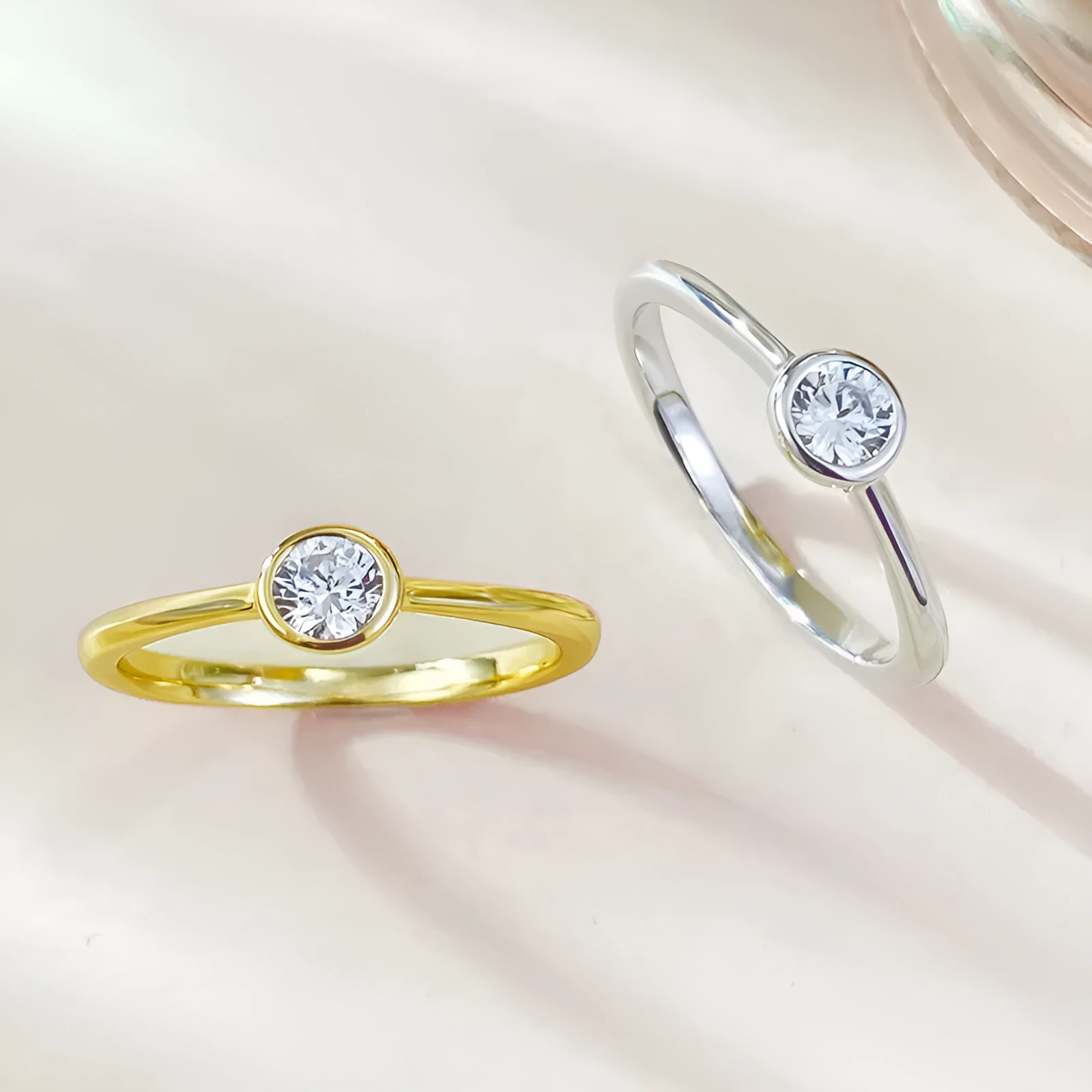 Minimalist crown-shaped silver ring in gold or platinum finish, shown in a simple setting.