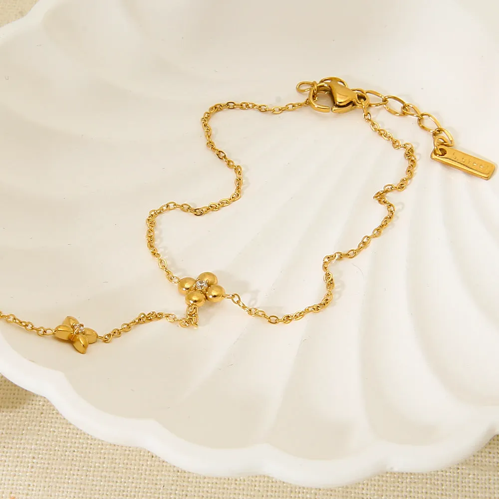 Women's stainless steel bracelet with geometric floral and eight-pointed star design in gold colour