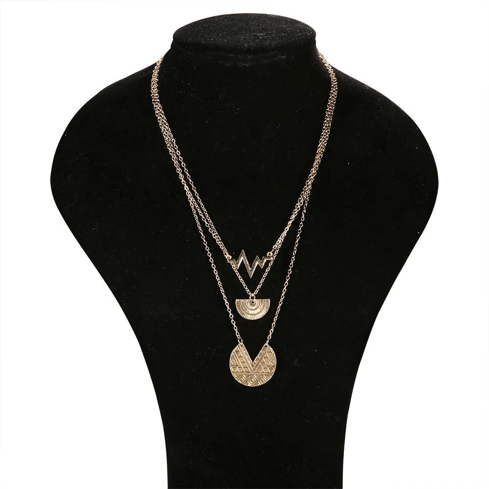 Gold multi-layer round alloy necklace with electroplated finish on white background