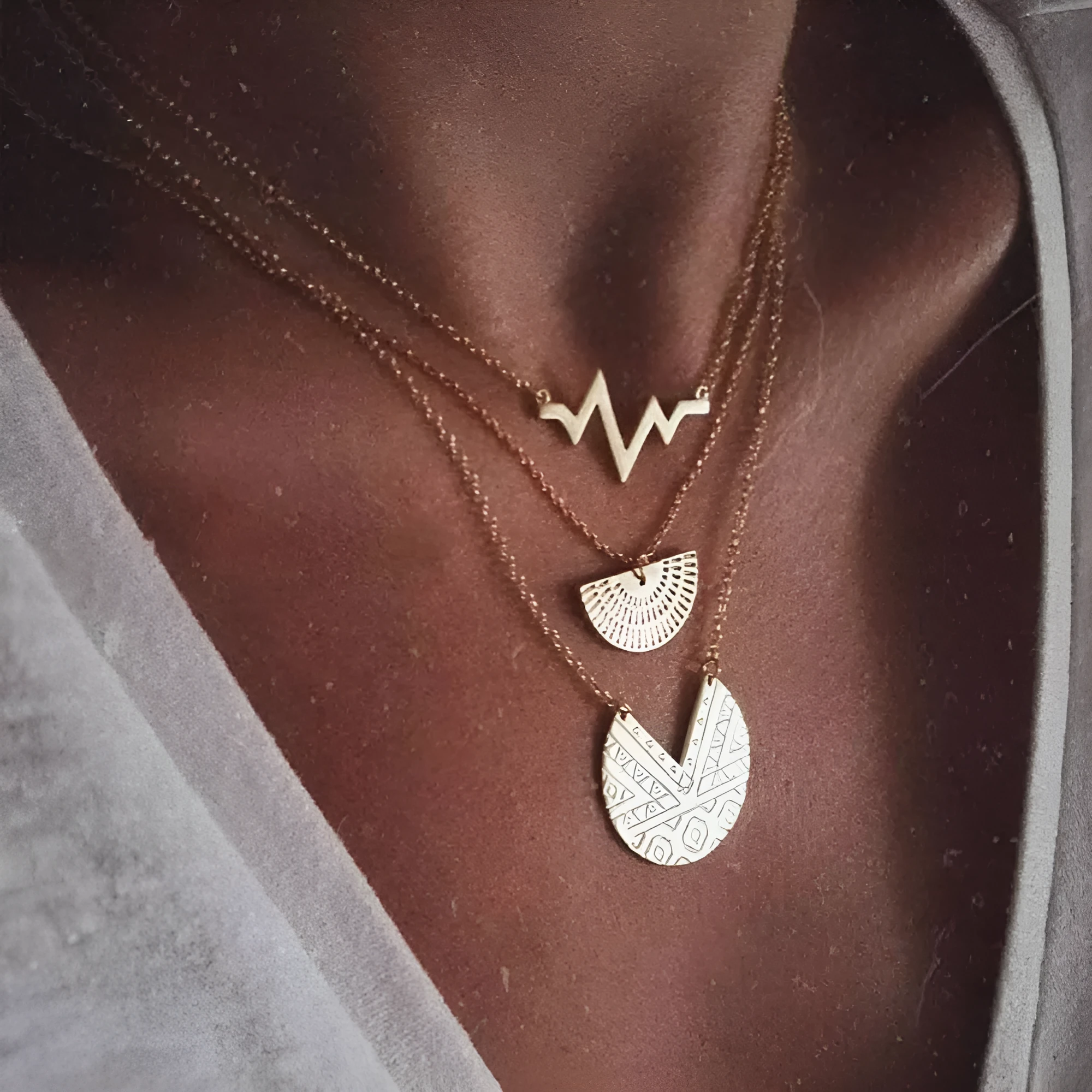 Gold multi-layer round alloy necklace with electroplated finish on white background