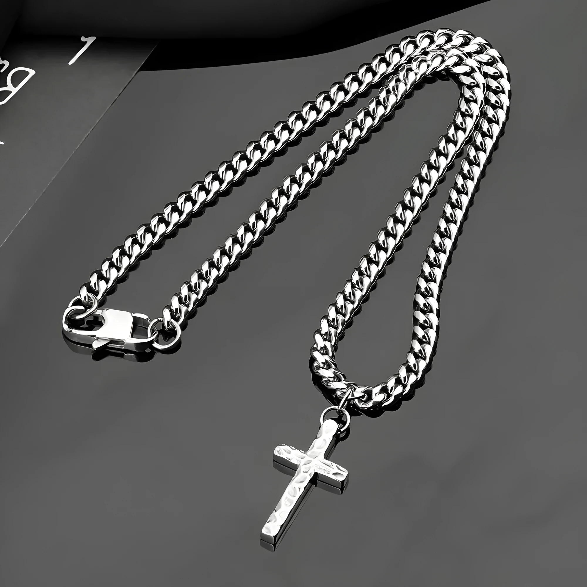 Titanium steel Cuban chain necklace in steel colour with geometric links on neutral background