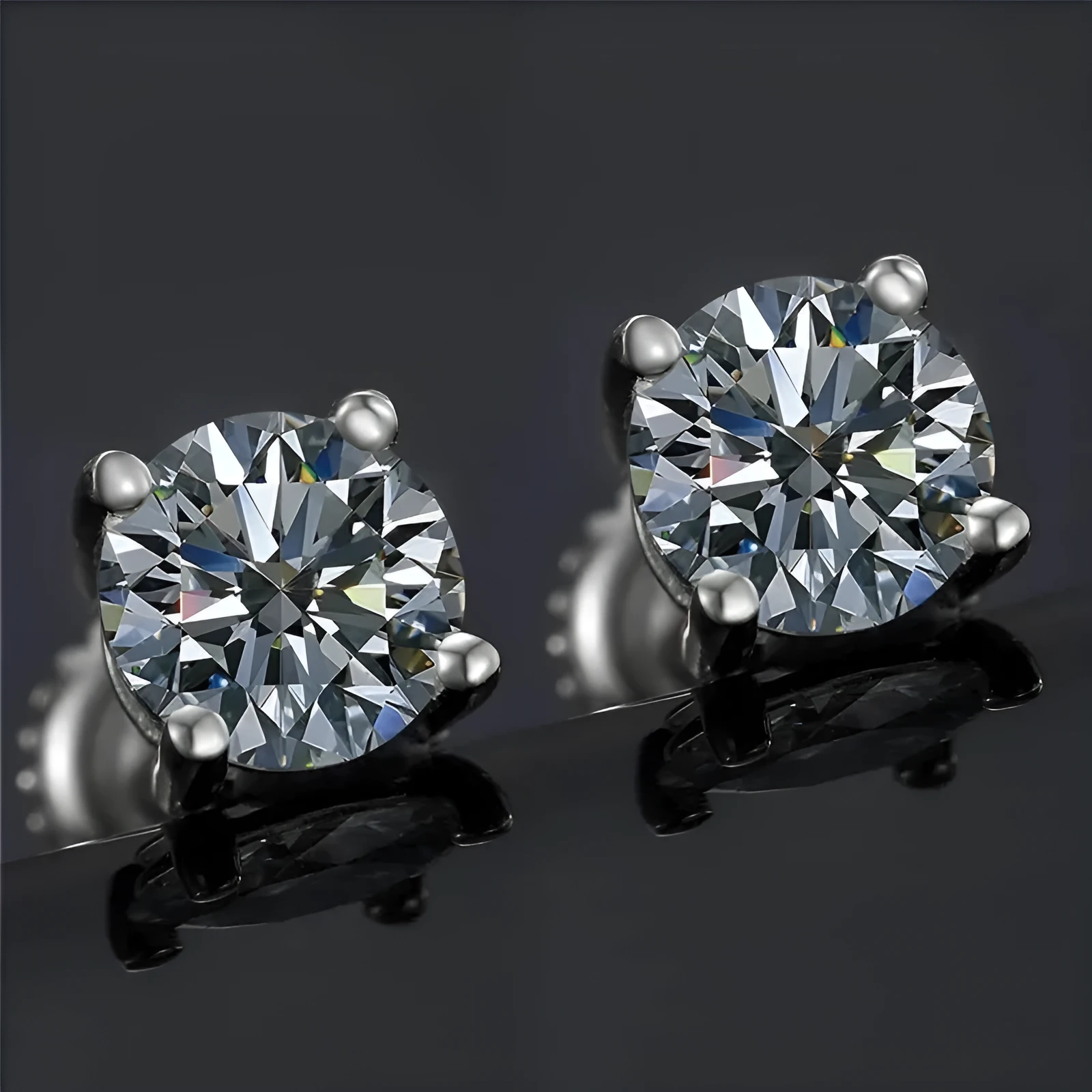 Close-up of a women's silver screw back moissanite stud earring with a four claw setting and geometric cut stone.