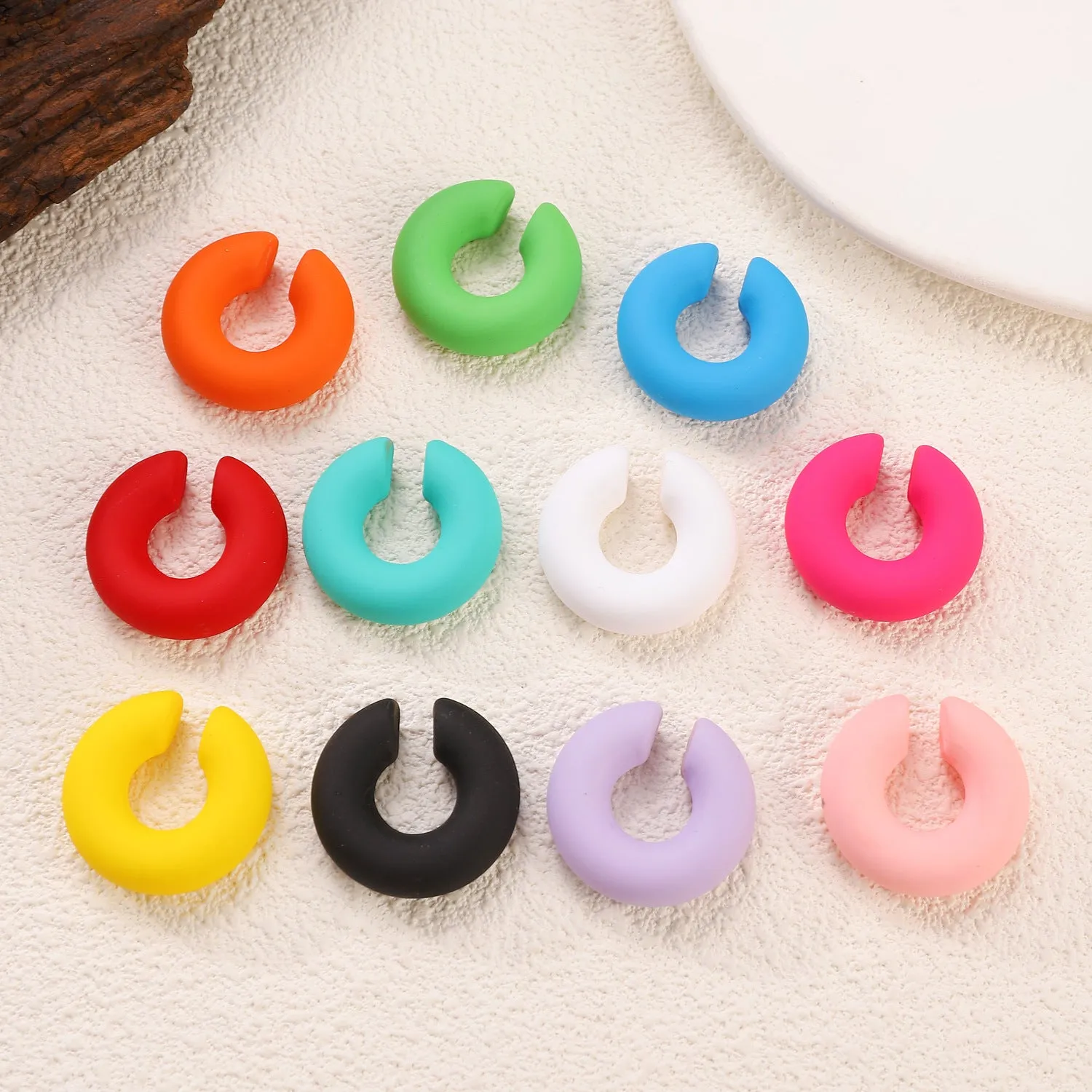 A pair of matte finish, coarse round C-shaped clip-on earrings for women in a choice of fifteen candy colours.