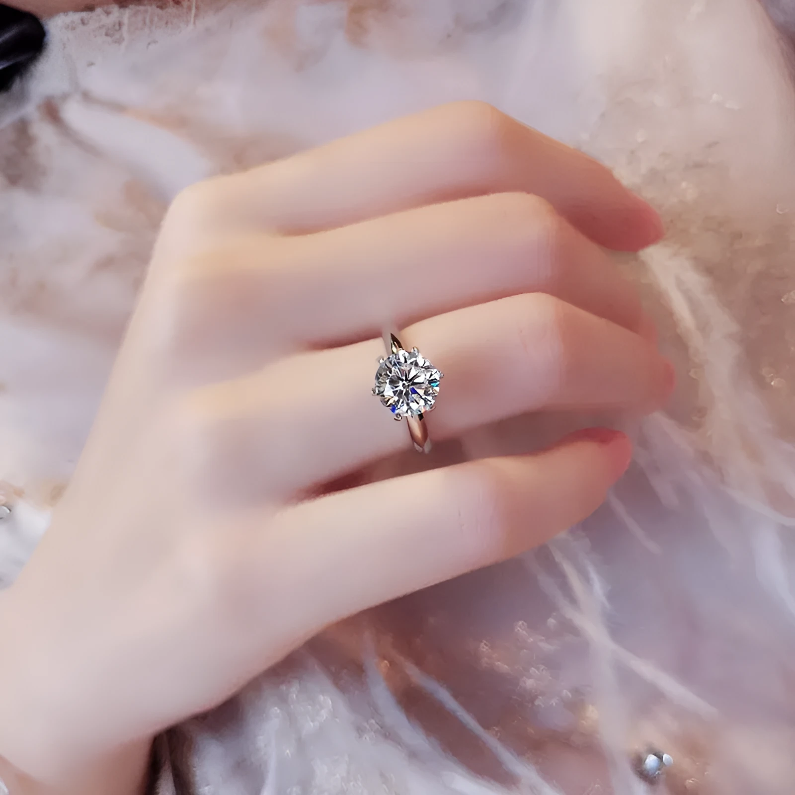 White gold plated six-claw zircon ring with a geometric design on a finger.