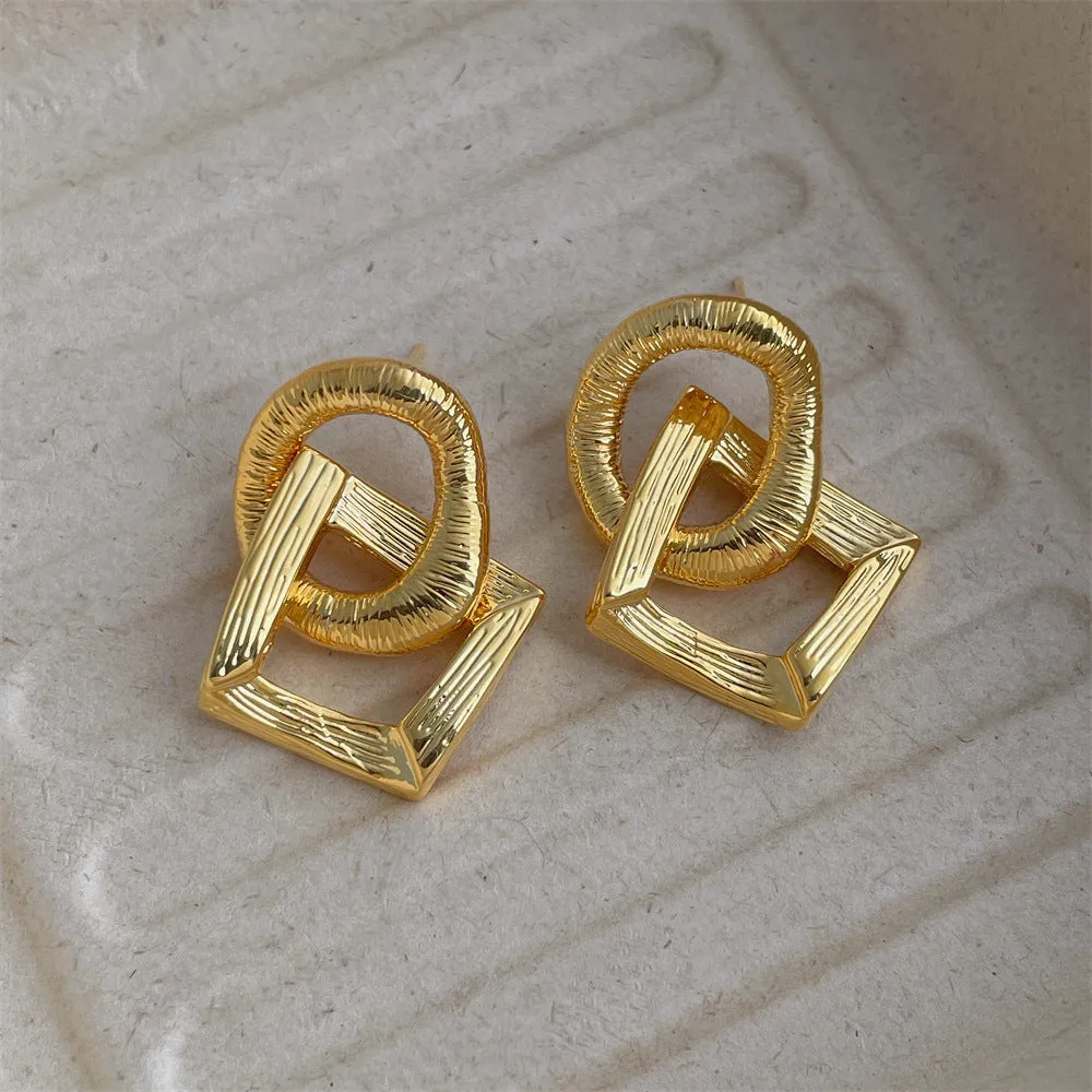 Geometric circle pendant earrings in gold or silver electroplated finish on copper, measuring 3.4cm height
