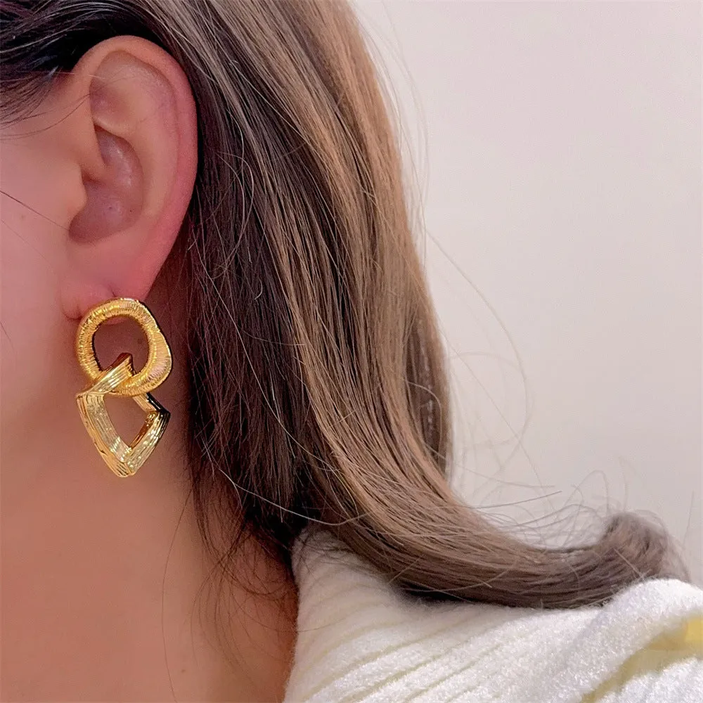 Geometric circle pendant earrings in gold or silver electroplated finish on copper, measuring 3.4cm height