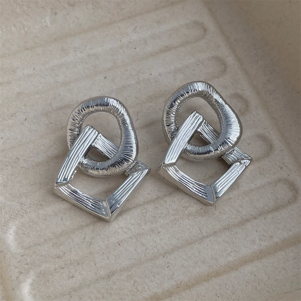 Geometric circle pendant earrings in gold or silver electroplated finish on copper, measuring 3.4cm height