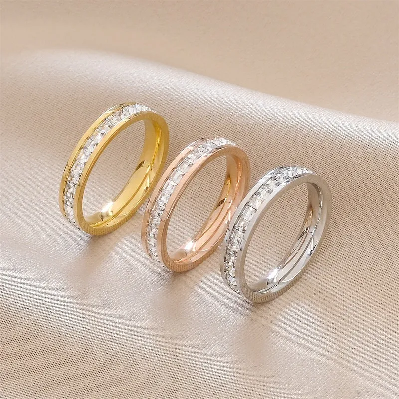 Stainless steel geometric star ring with zircon inlay in gold finish on white background