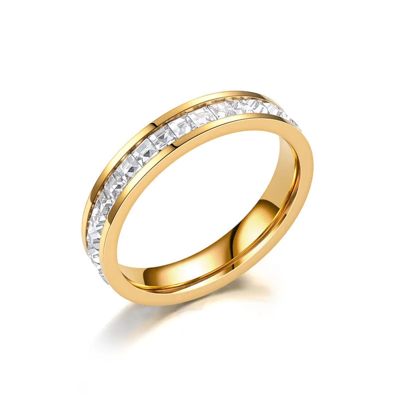 Stainless steel geometric star ring with zircon inlay in gold finish on white background