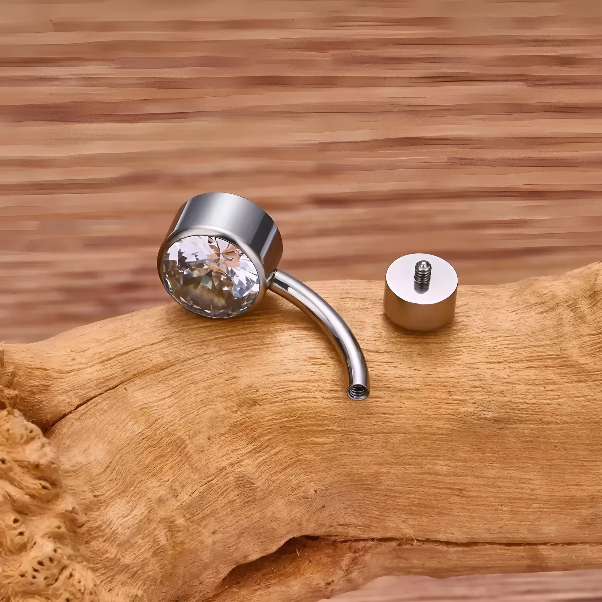Titanium alloy double-headed navel stud with zircon accents in various colours and lengths.