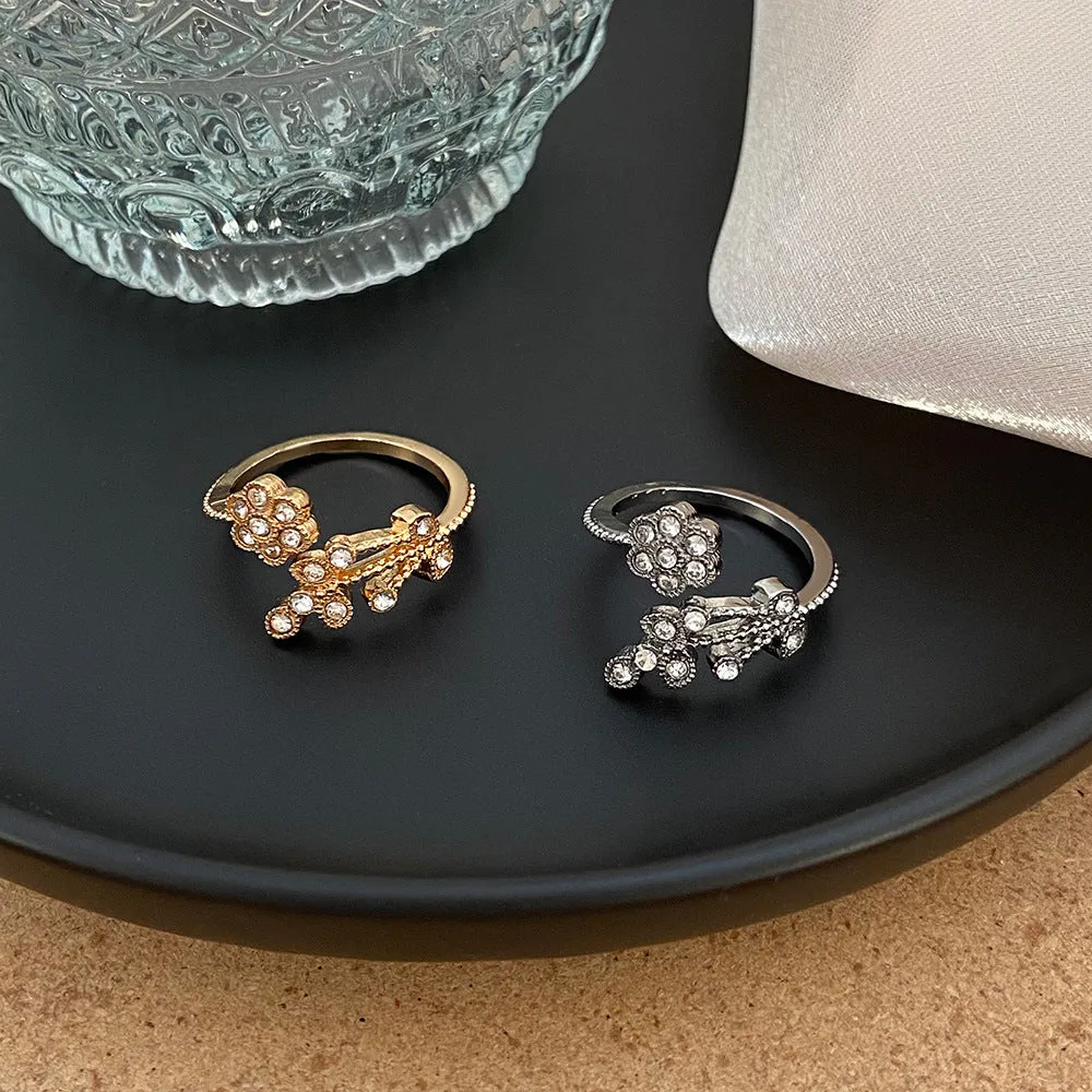 Women's diamond flower leaves open ring in gold and white colour options showing floral design