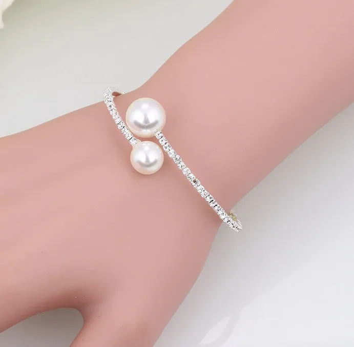 Bridal crystal pearl diamond drill collar necklace and bracelet set in gold and silver tones on white background