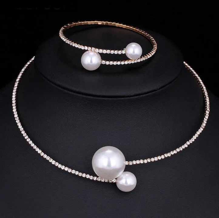 Bridal crystal pearl diamond drill collar necklace and bracelet set in gold and silver tones on white background