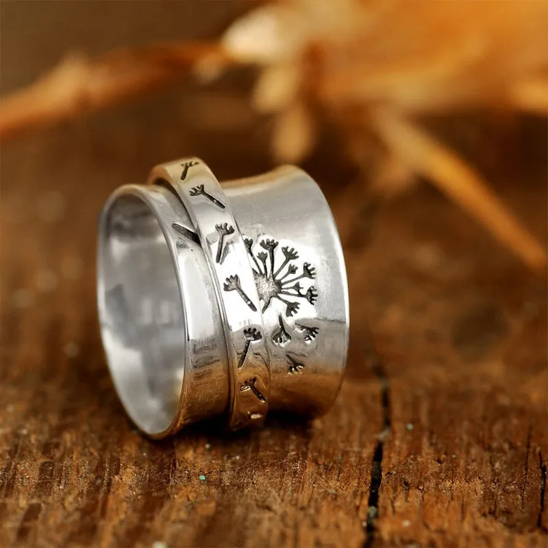 Silver rotatable flower ring showing floral design on alloy band