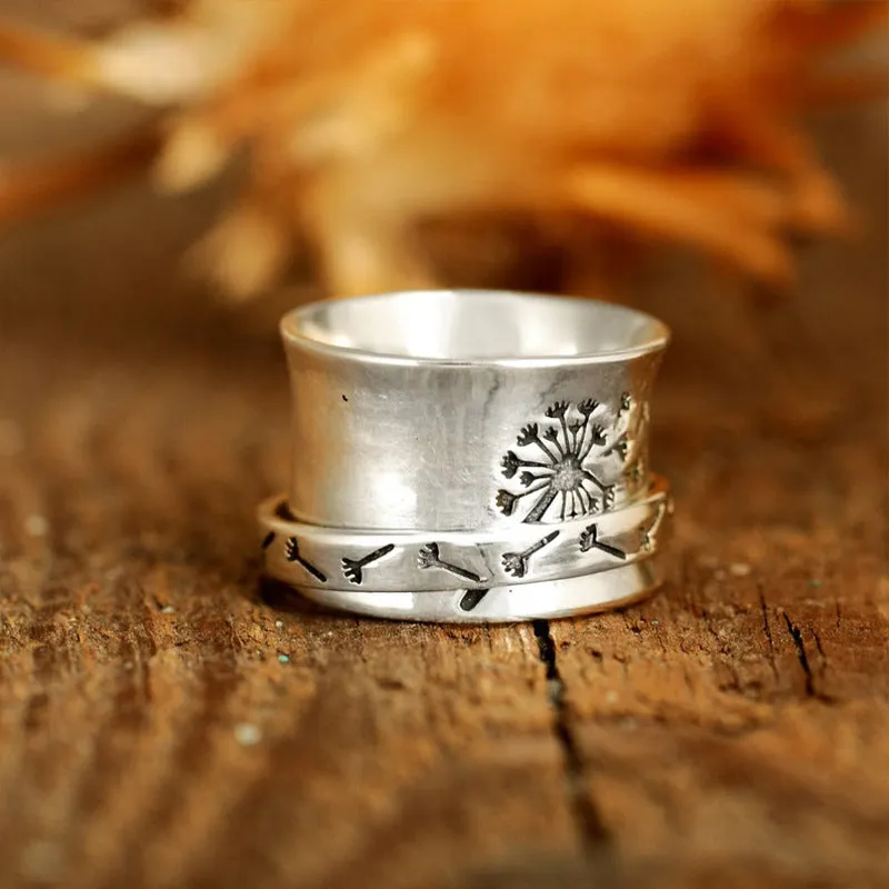 Silver rotatable flower ring showing floral design on alloy band