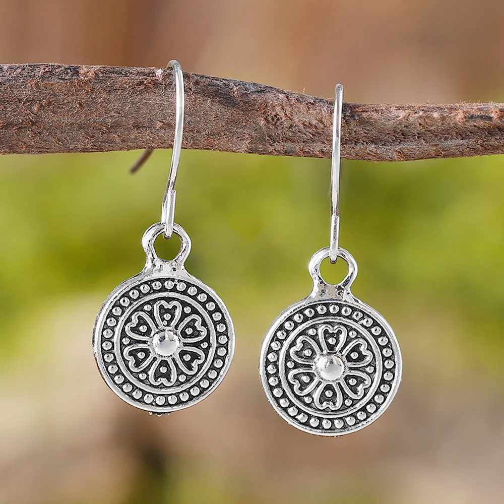 A pair of geometric Bohemian-style retro earrings with a distressed round ethnic print on zinc alloy.