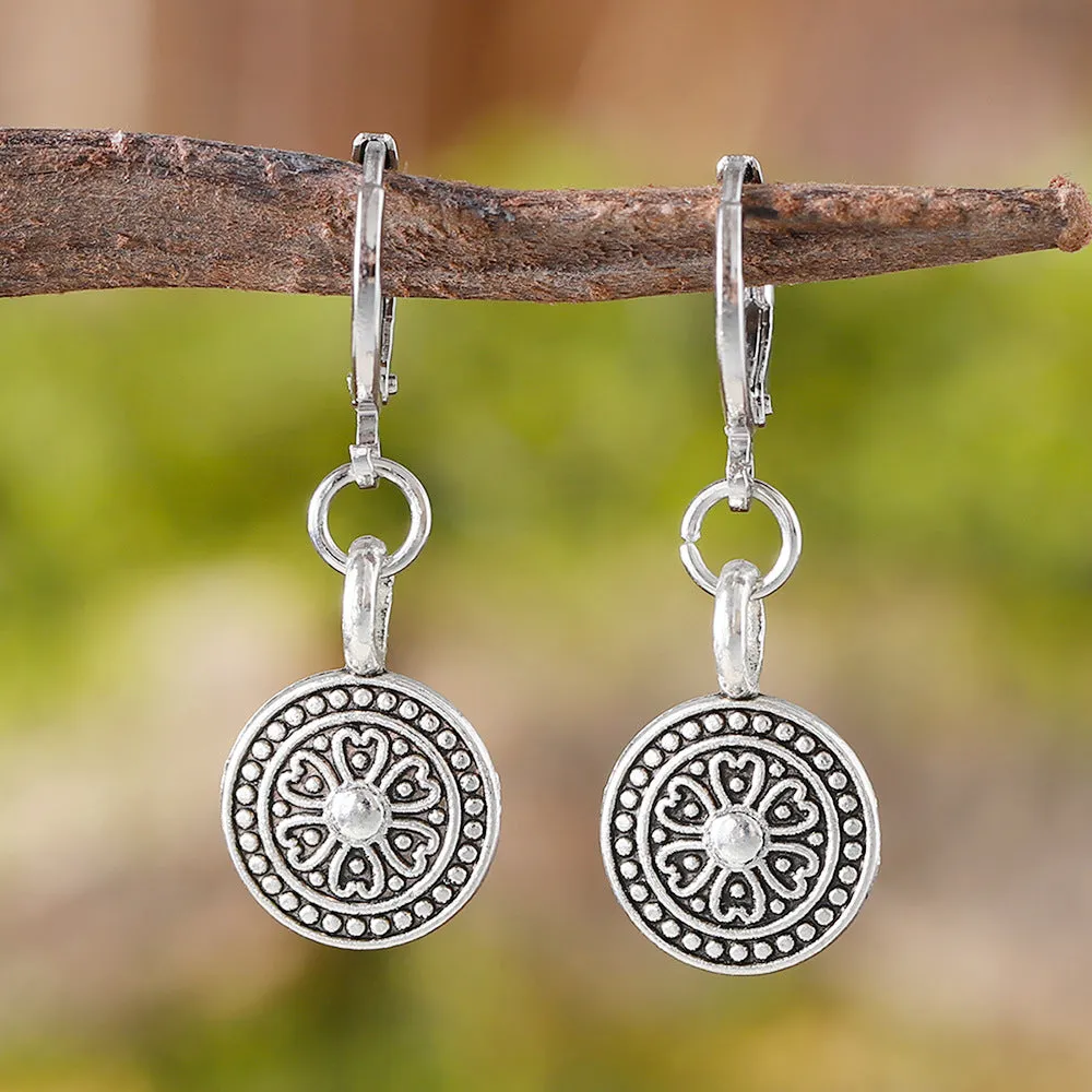 A pair of geometric Bohemian-style retro earrings with a distressed round ethnic print on zinc alloy.