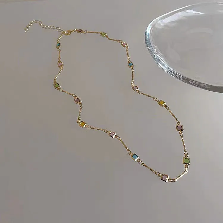 Square colour geometric alloy clavicle chain necklace with artificial crystal detail in gold tone.