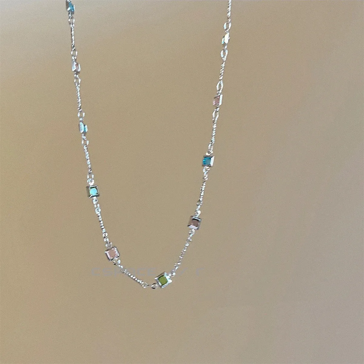 Square colour geometric alloy clavicle chain necklace with artificial crystal detail in gold tone.