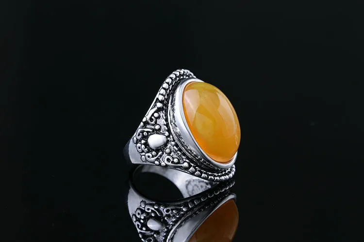 Geometric retro alloy ring in antique silver amber colour on a grey background.