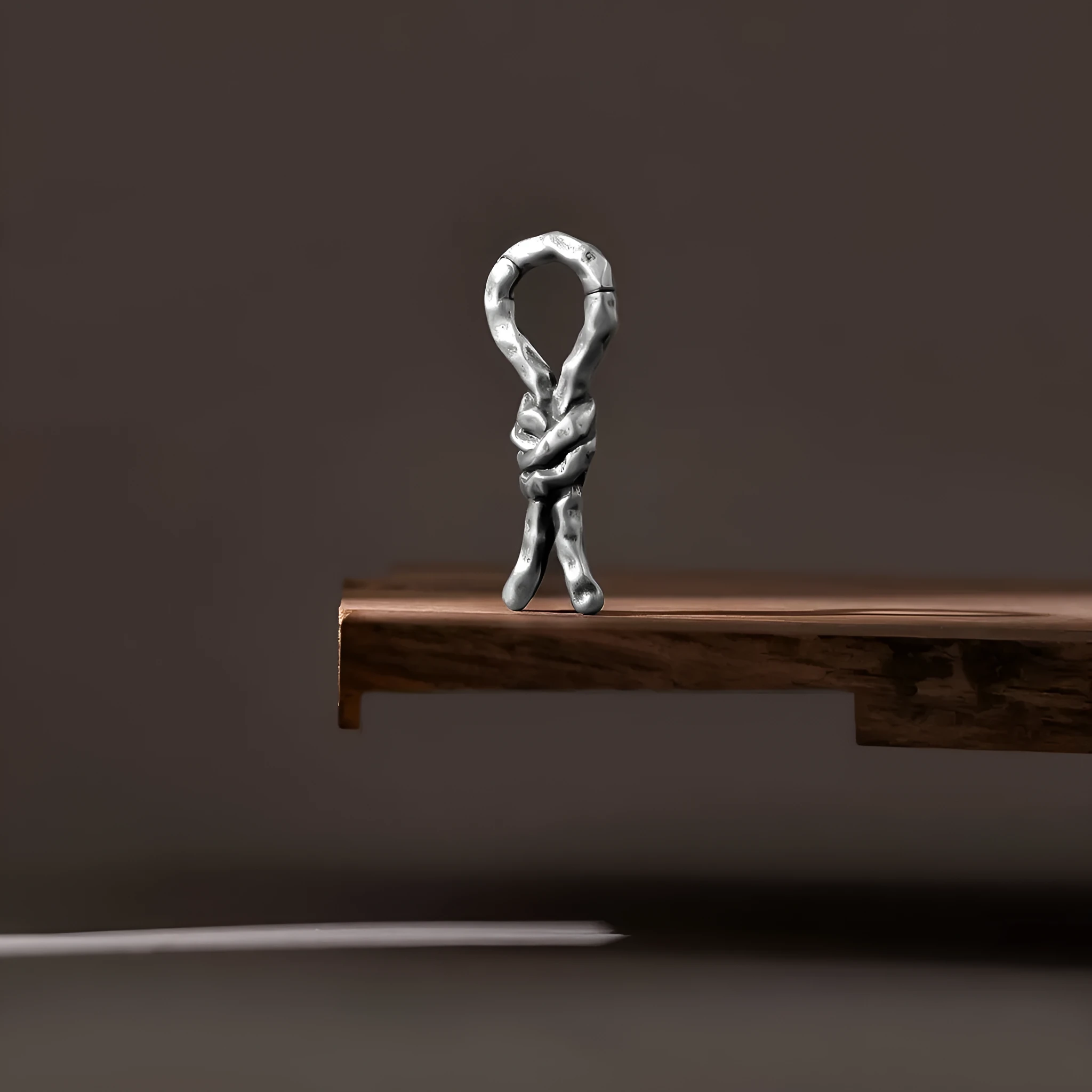 Close-up of Creative Bends And Hitches copper cartilage earrings with a 4mm gauge and retro bending design.