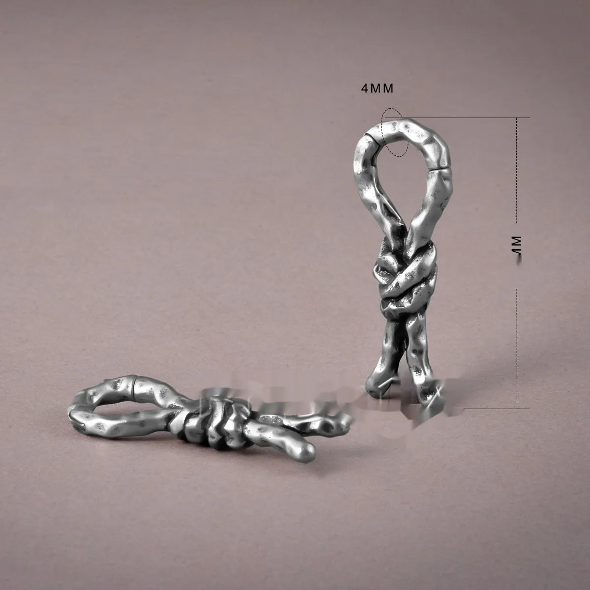 Close-up of Creative Bends And Hitches copper cartilage earrings with a 4mm gauge and retro bending design.