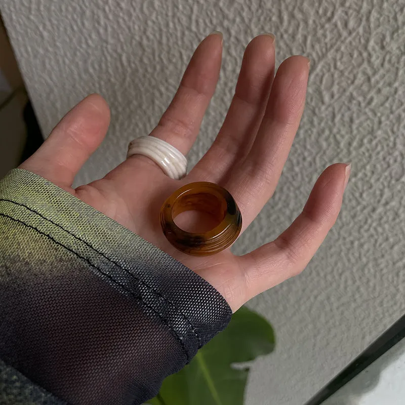Geometric resin wide ring with irregular Chinese-inspired design in brown and white colours