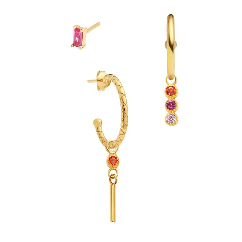 Set of three copper geometric earrings with zircon inlay on a neutral background