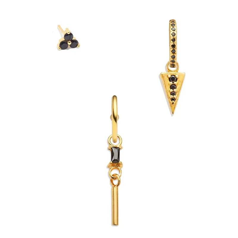 Set of three copper geometric earrings with zircon inlay on a neutral background