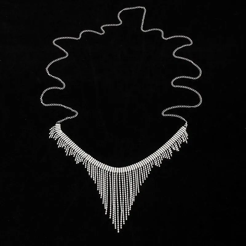 Silvery rhinestone body chain laid flat on a white surface showing metal links and clear stones