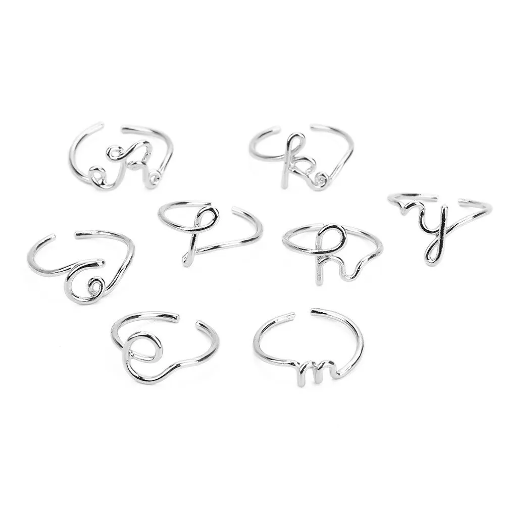 Gold coloured unisex alloy initial ring with letter A geometric shape on a flat surface