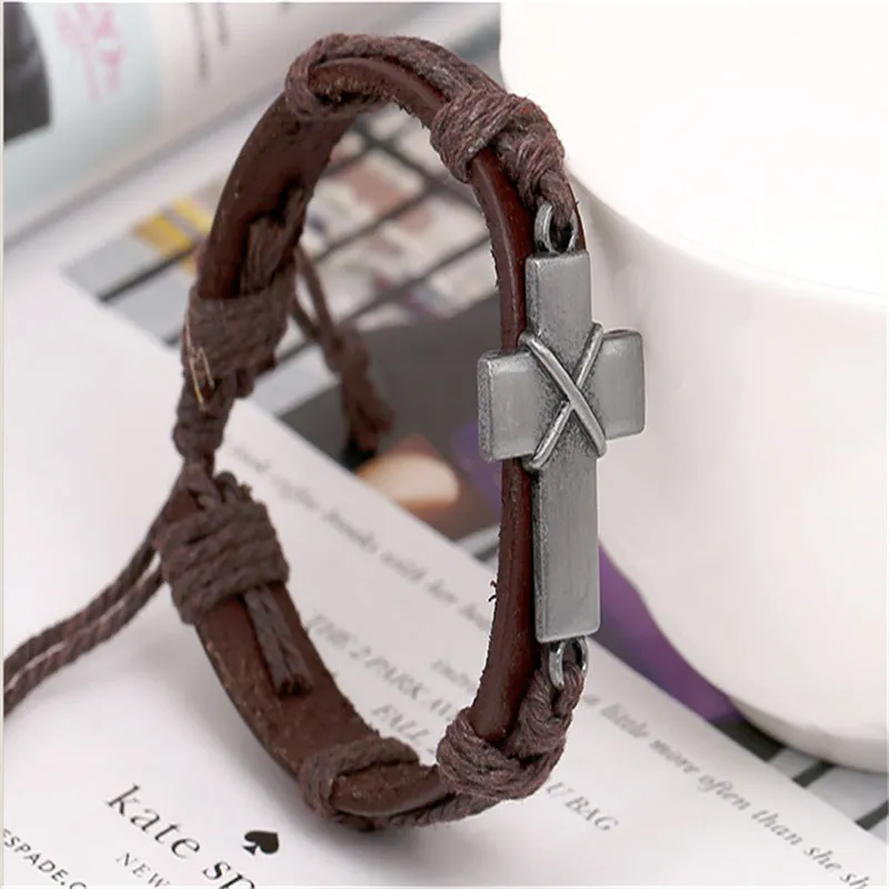 Brown leather cross bracelet with alloy accent, adjustable drawstring, vintage style on wrist