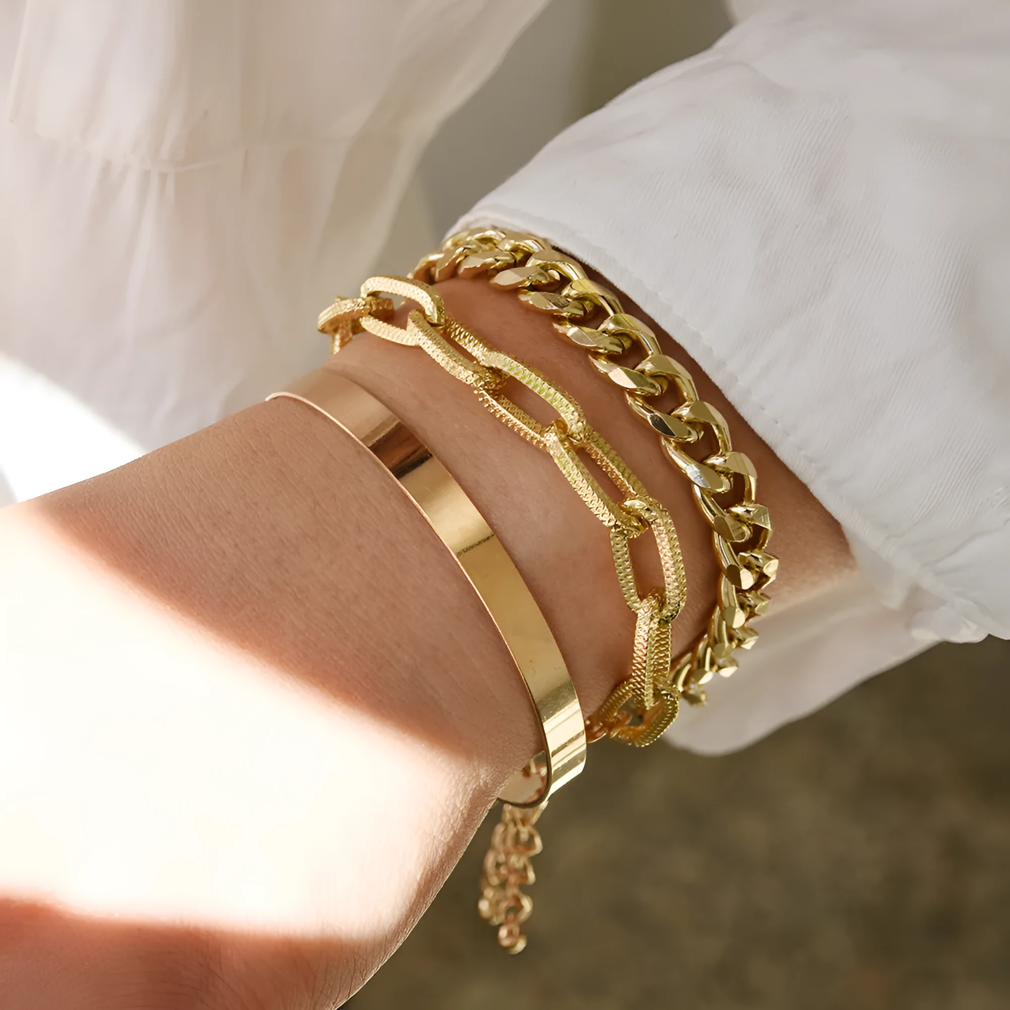 Set of 6 women's stretch bracelets with natural glass stones and gold beads arranged on a white surface