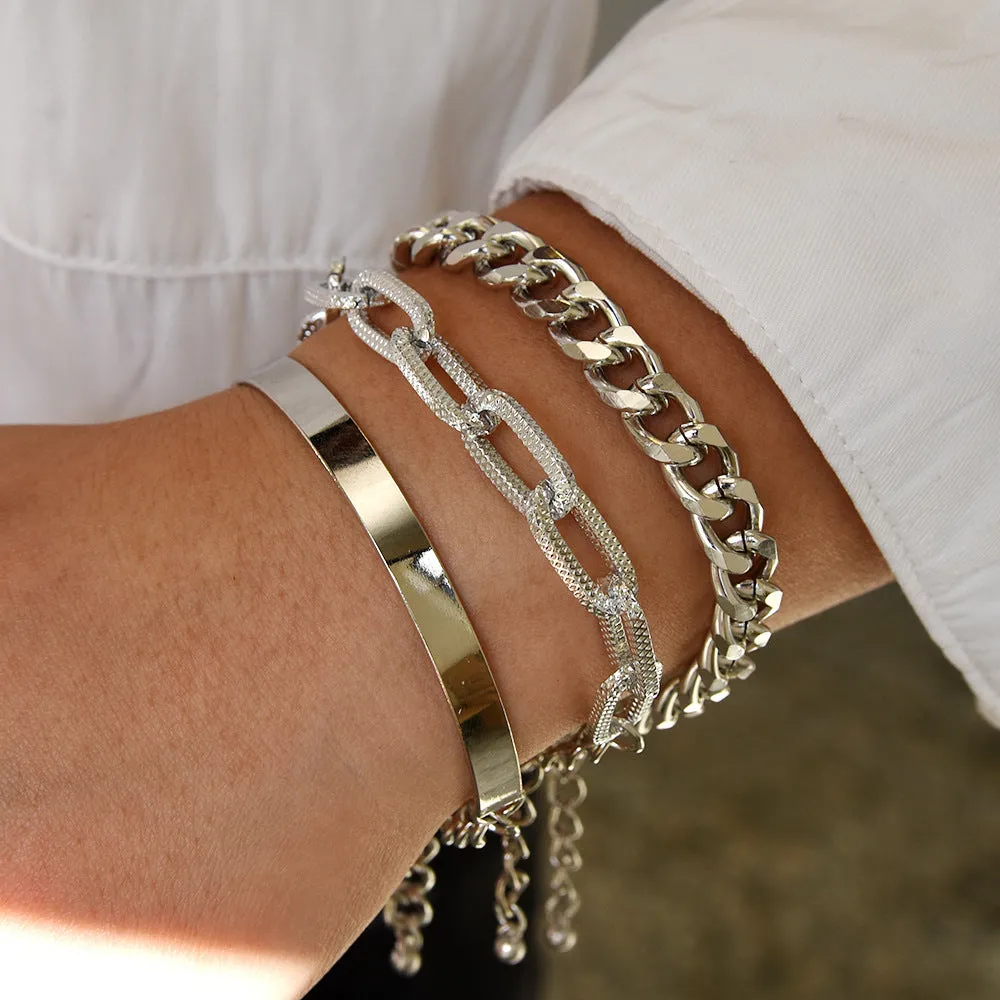 Set of 6 women's stretch bracelets with natural glass stones and gold beads arranged on a white surface