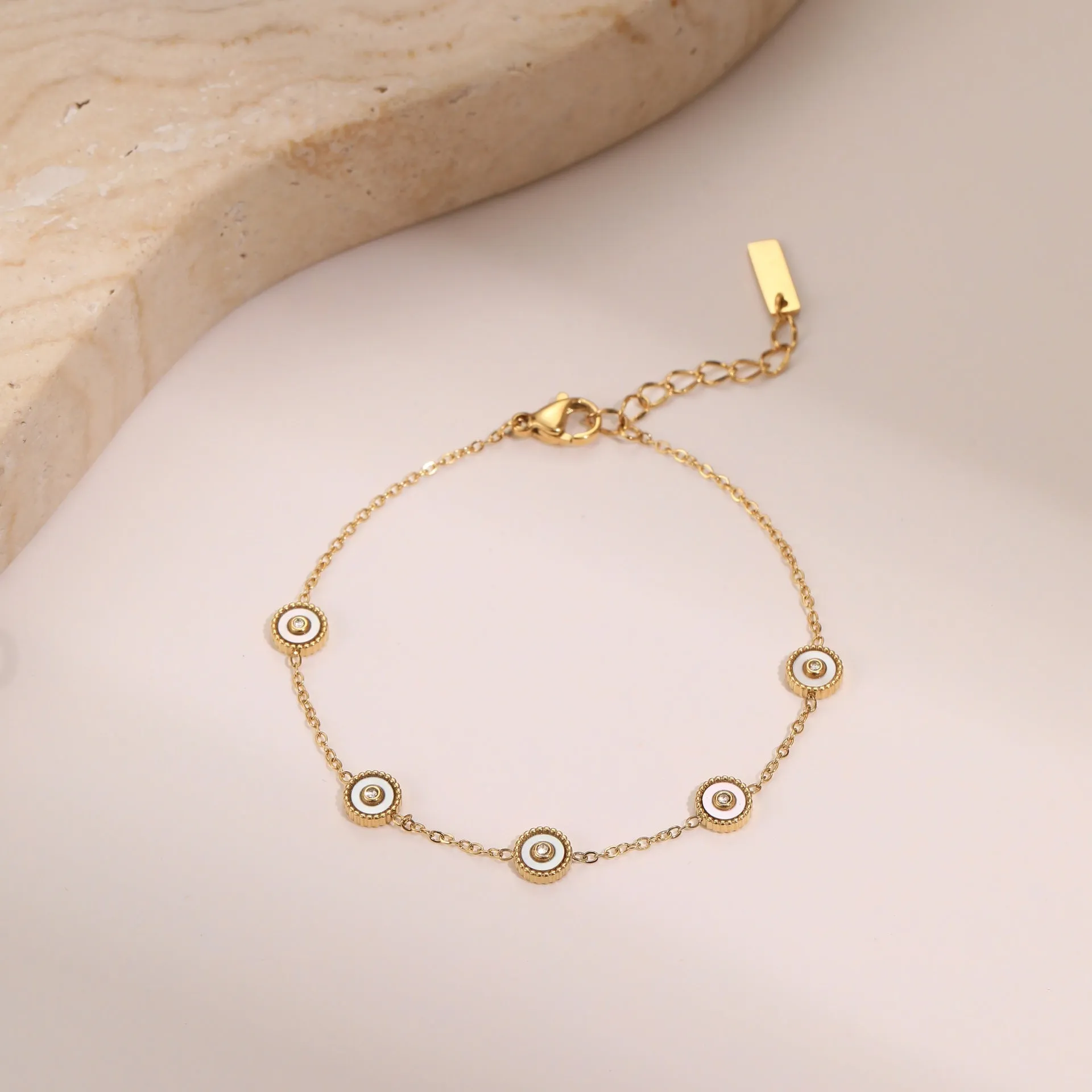 Women's stainless steel bracelet with 18K gold plating and geometric fritillary charm, includes matching necklace