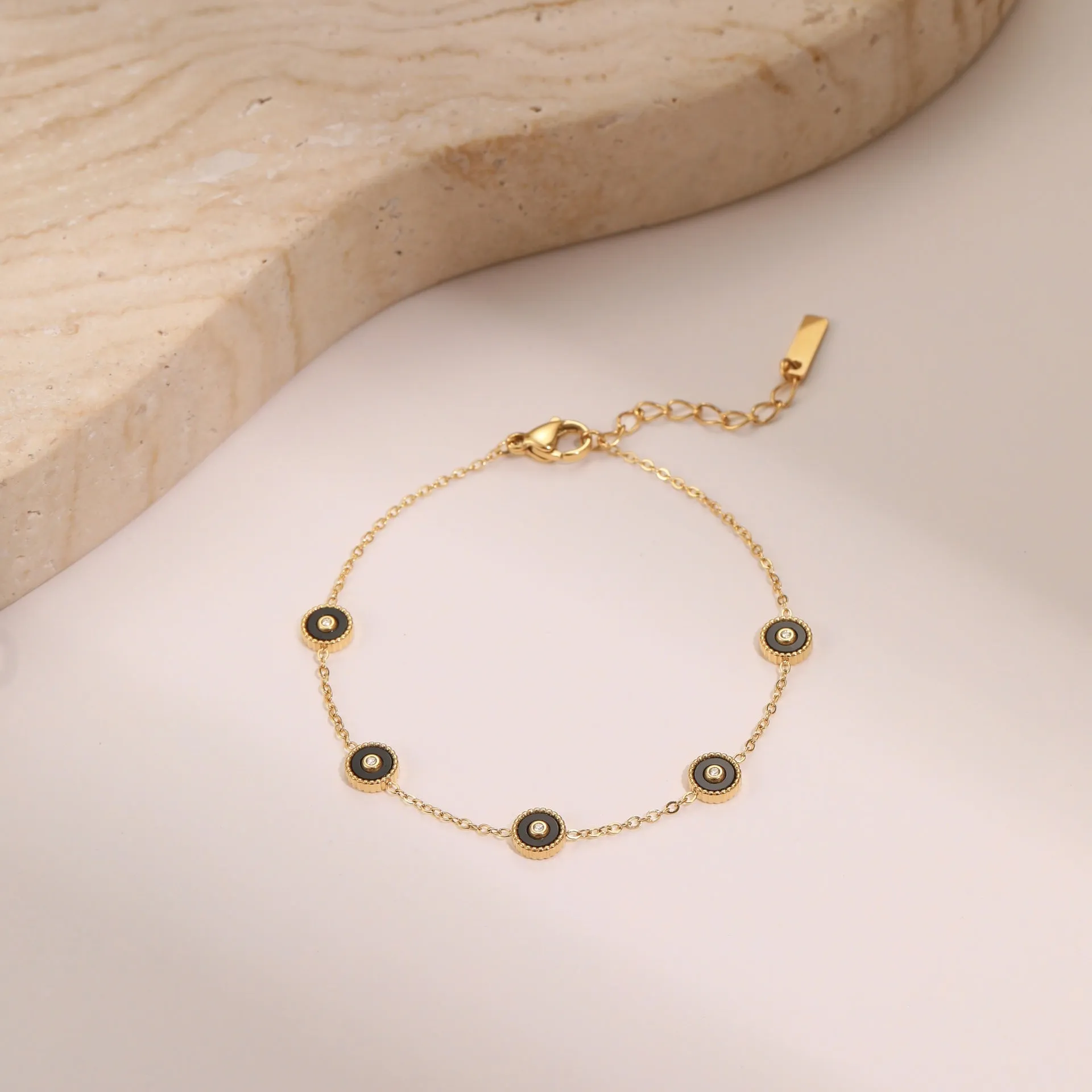 Women's stainless steel bracelet with 18K gold plating and geometric fritillary charm, includes matching necklace