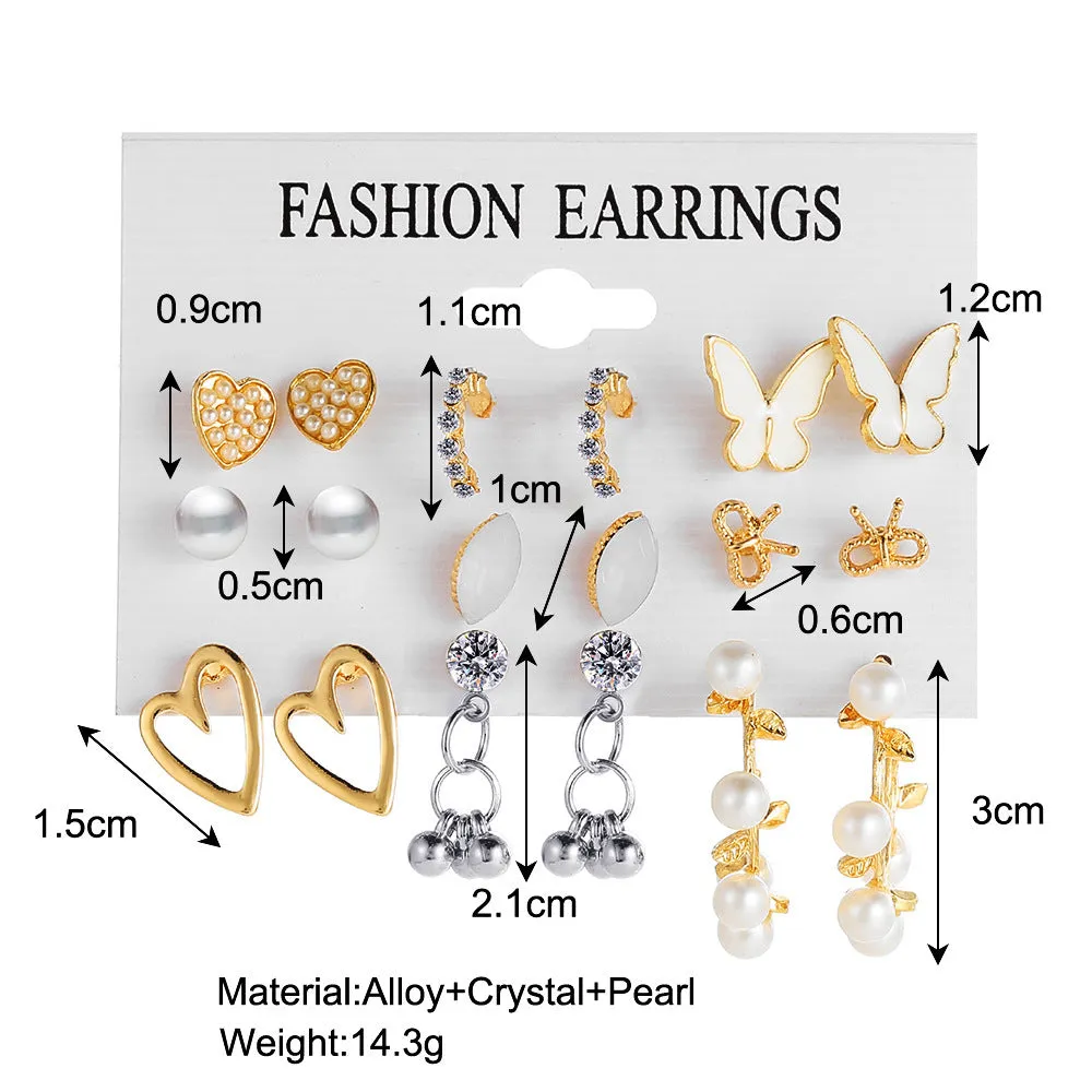Nine pairs of gold alloy earrings with butterfly and love designs arranged together